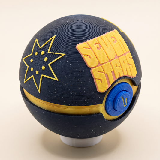 Angled view of the Seven Stars Memory Capsule showing the seven-pointed star on its sparkly black top shell