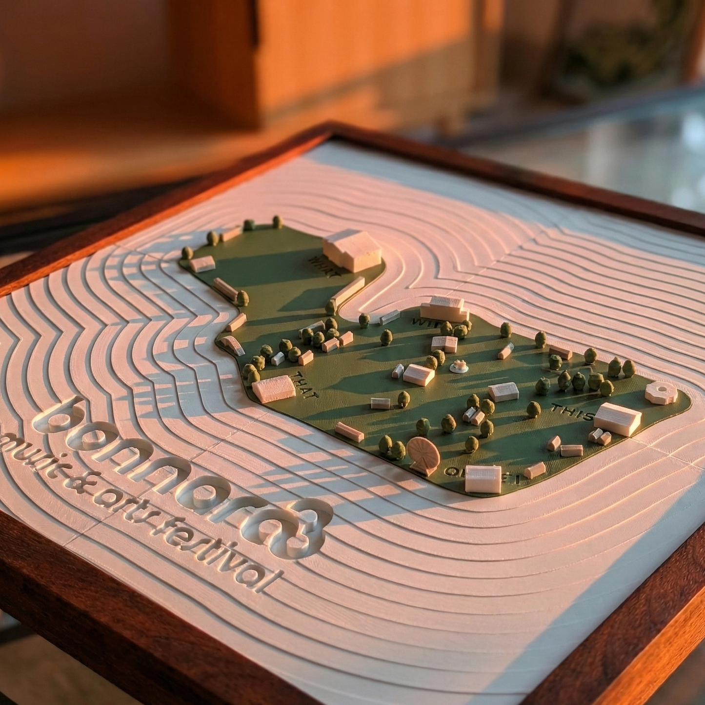3D model of a landscape with 'Penn State Music & Arts Festival' text on a wooden base.