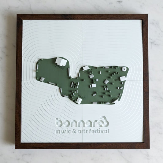 Framed map of a venue with 'bonnaroo' branding on a marble surface