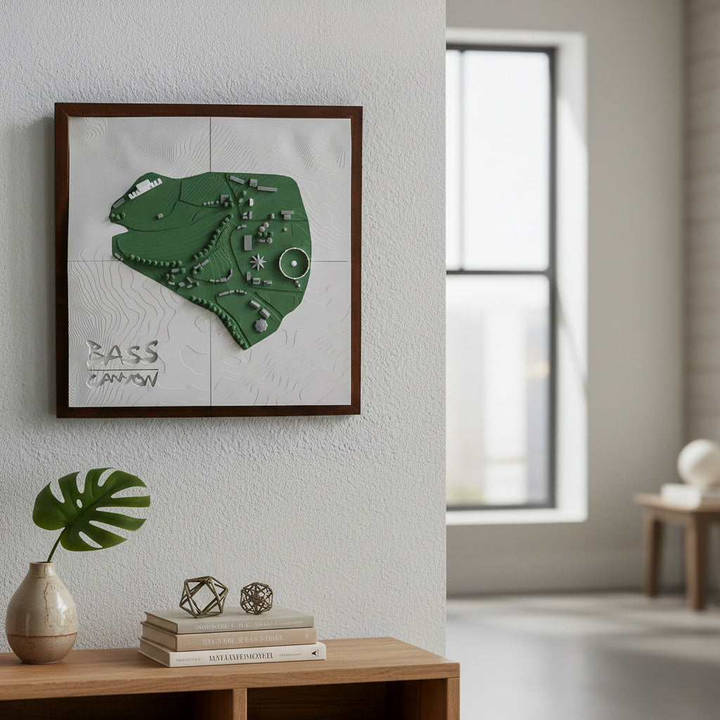 Framed green wall art piece on a white wall with a window in the background.