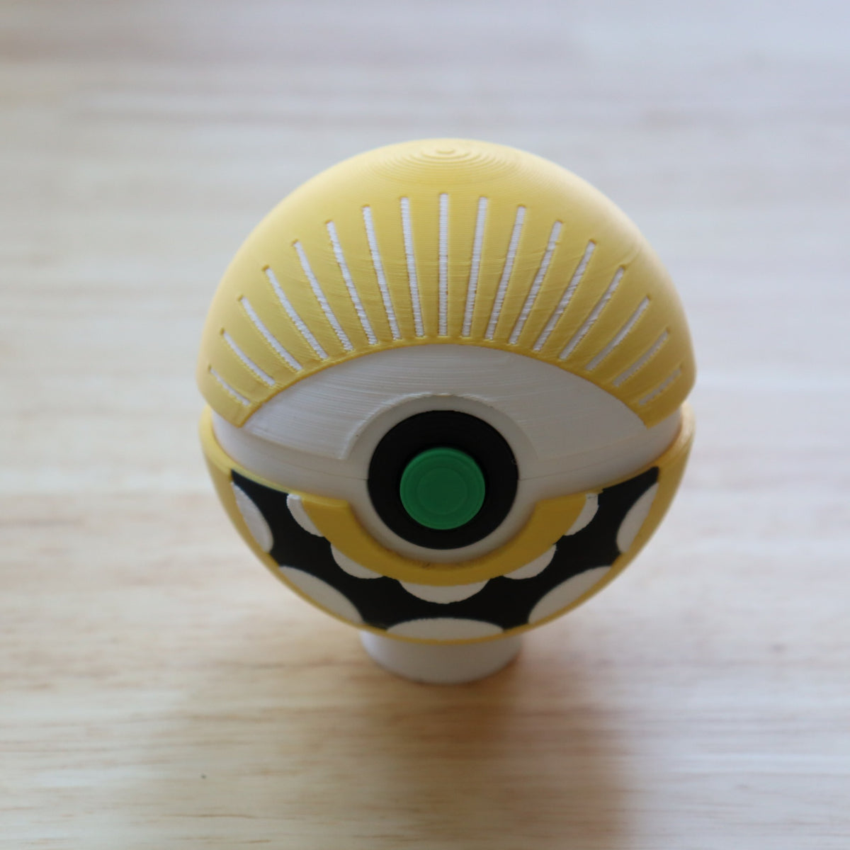 Cyclops Memory Capsule open with colorful kandi bracelets inside, showing the keepsake storage space and hinged lid.
