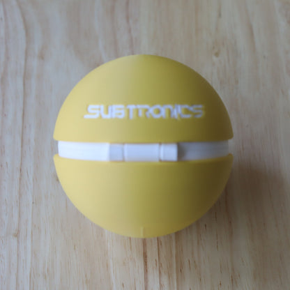 Rear view of the yellow Cyclops Memory Capsule with white Subtronics lettering and a white hinge.