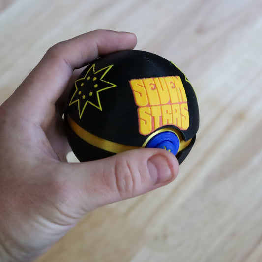 Hand holding the Seven Stars Memory Capsule at an angle to show its size